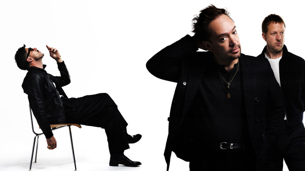 Mumford & Sons band members posing for the camera against a white background.