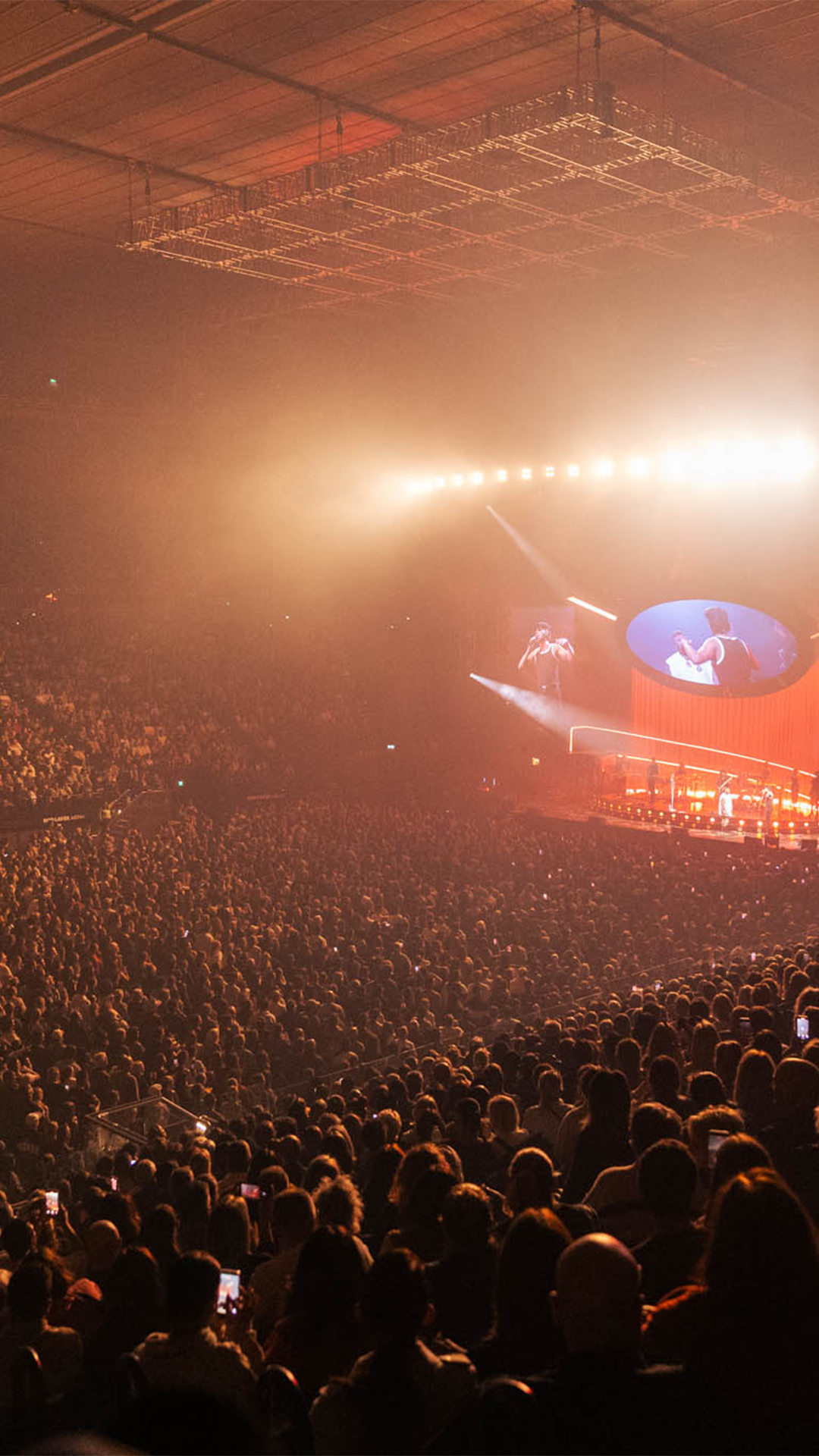 A packed crowd enjoying a concert at Rod Laver Arena.